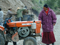 Monk Inspecting a Tractor